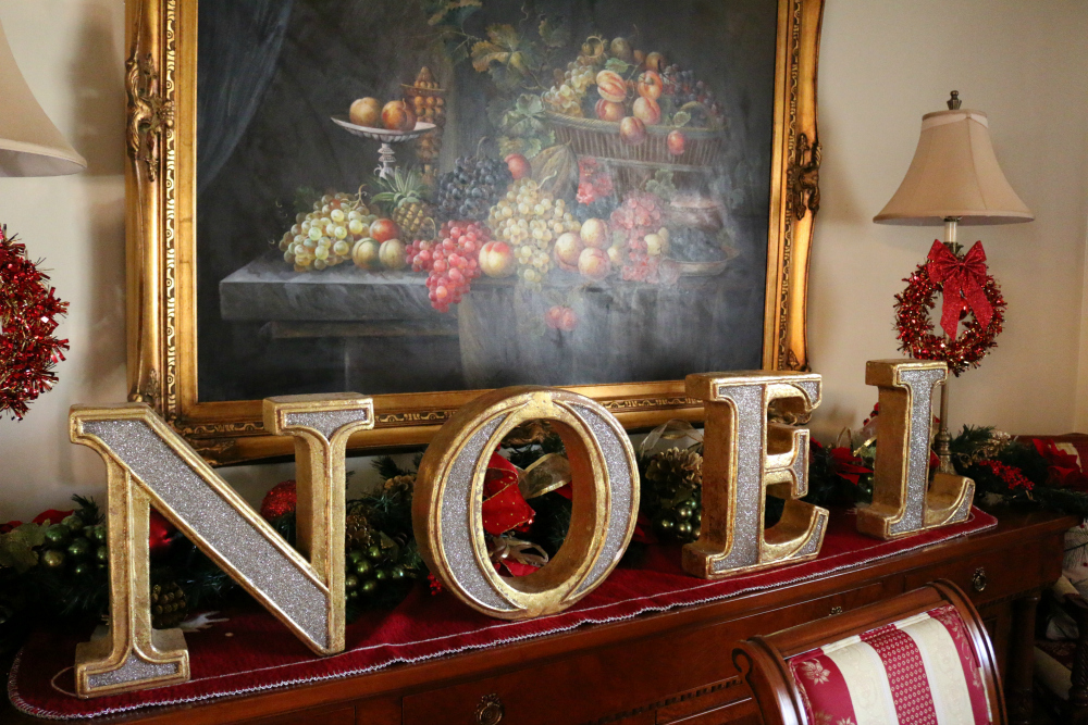 NOEL - I cover the buffet with garland and this NOEL decor. I love it. Sometimes the "Elf on the Shelf" plays tricks on me and moves the letters around. He like to spell out LEON?! I think that might be his name. LOL