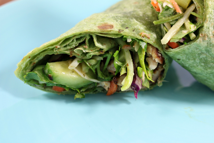 Thai Chicken Wrap load with cabbage, carrots, cilantro, scallions and a delicious Thai Peanut Sauce.