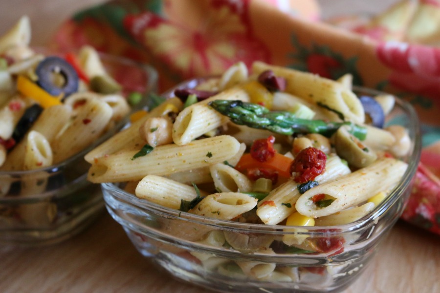 Three Olive Pasta Salad - pasta salad loves vegetables, you can use nearly any type of vegetable in pasta salad. I like using bell pepper, zucchini, asparagus, a little onion. In this recipe I added garbanzo beans and sun dried tomatoes. The sun dried tomatoes really give the salad a nice tangy bite, along with the three variaties, of olives. 