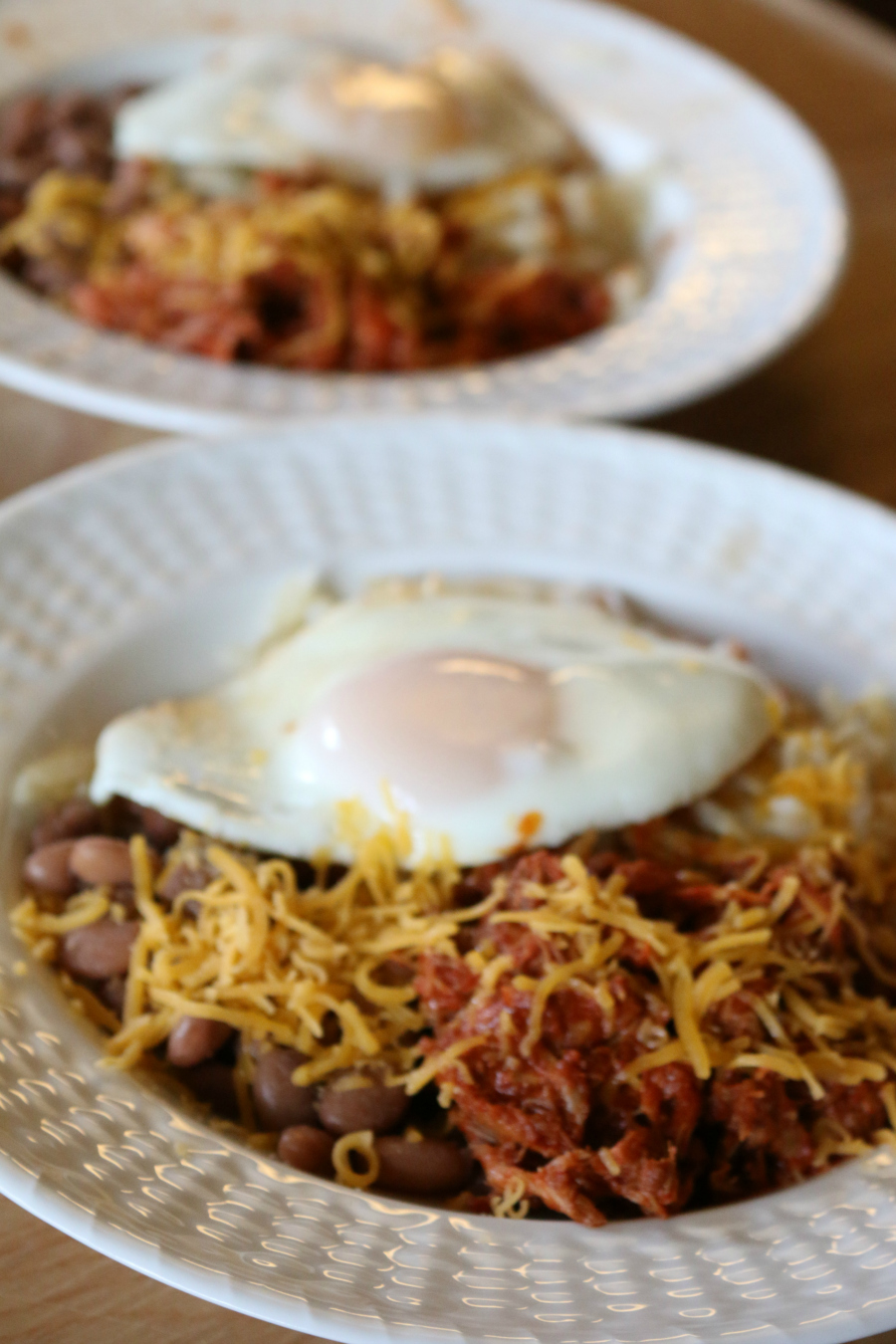 Carne Adovada Con Huevo - Carne Adovada Con Huevo - Pork marinated in Red Chile served beans, hash browns and a fried egg.