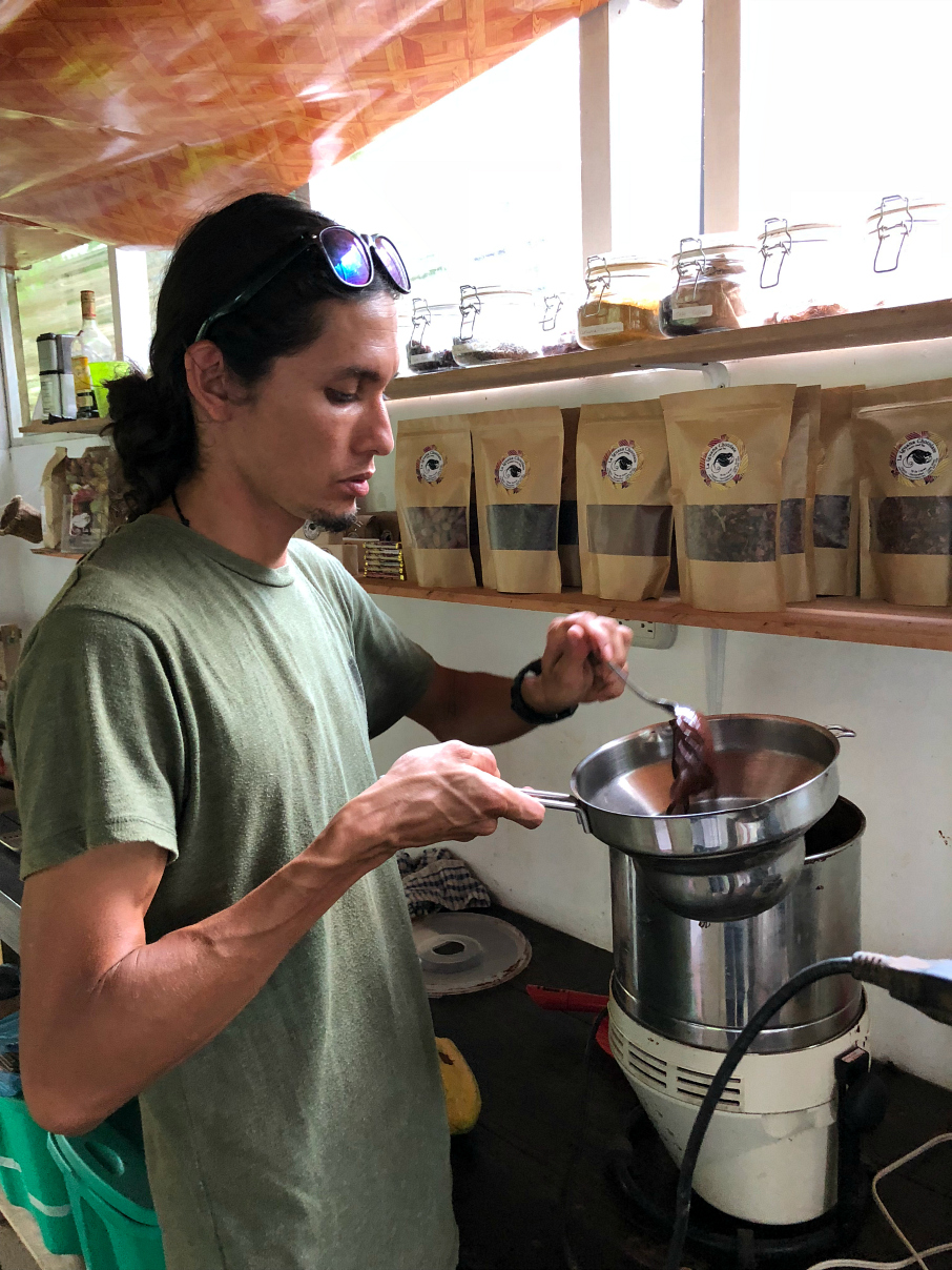 George melting the cocoa down to make chocolates and hot fudge with fresh cocoa. La Iguana Chocolate Costa Rica 
