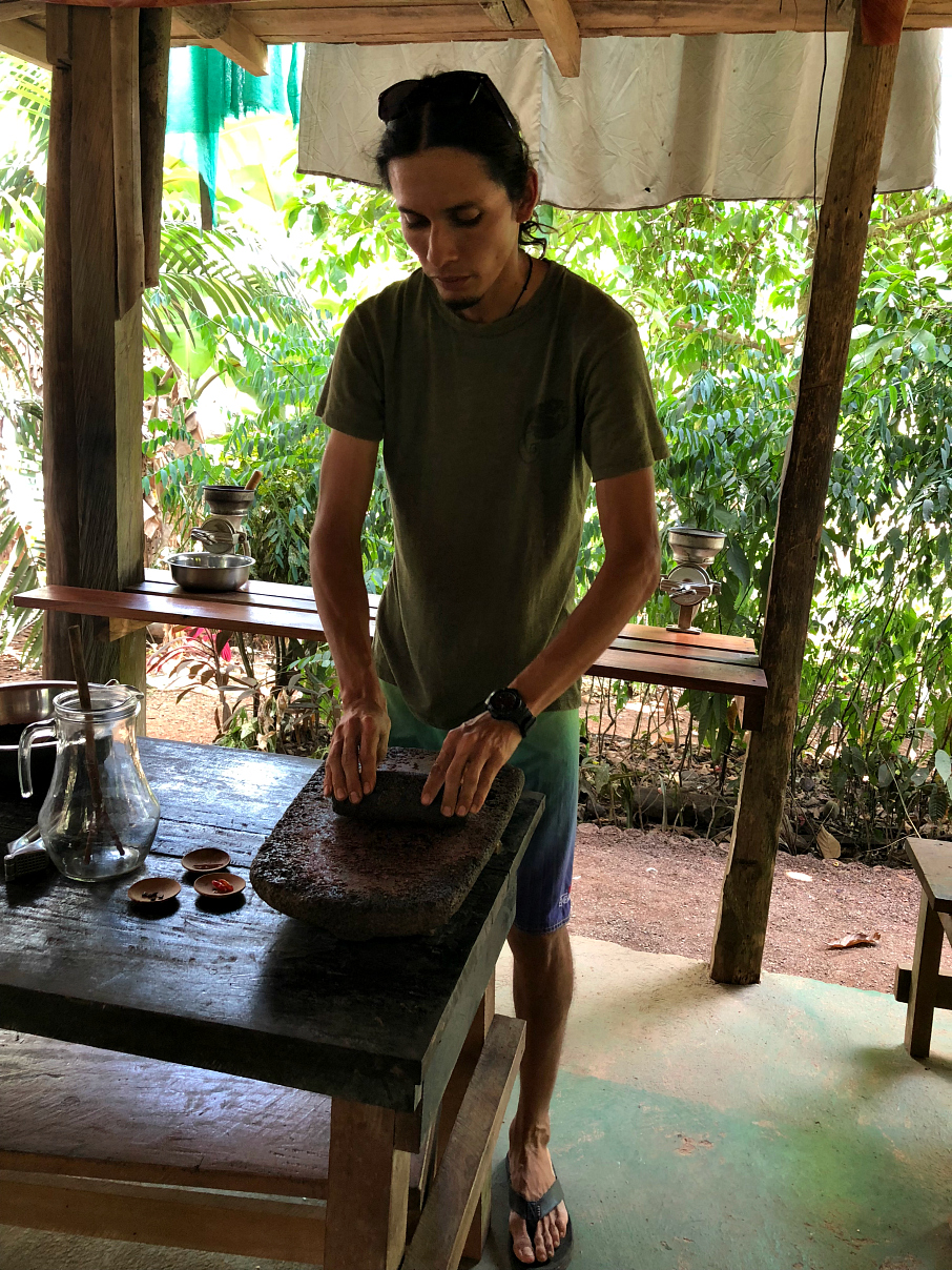 George crushing chocolate to make truffles. La Iguana Chocolate, Costa Rica 