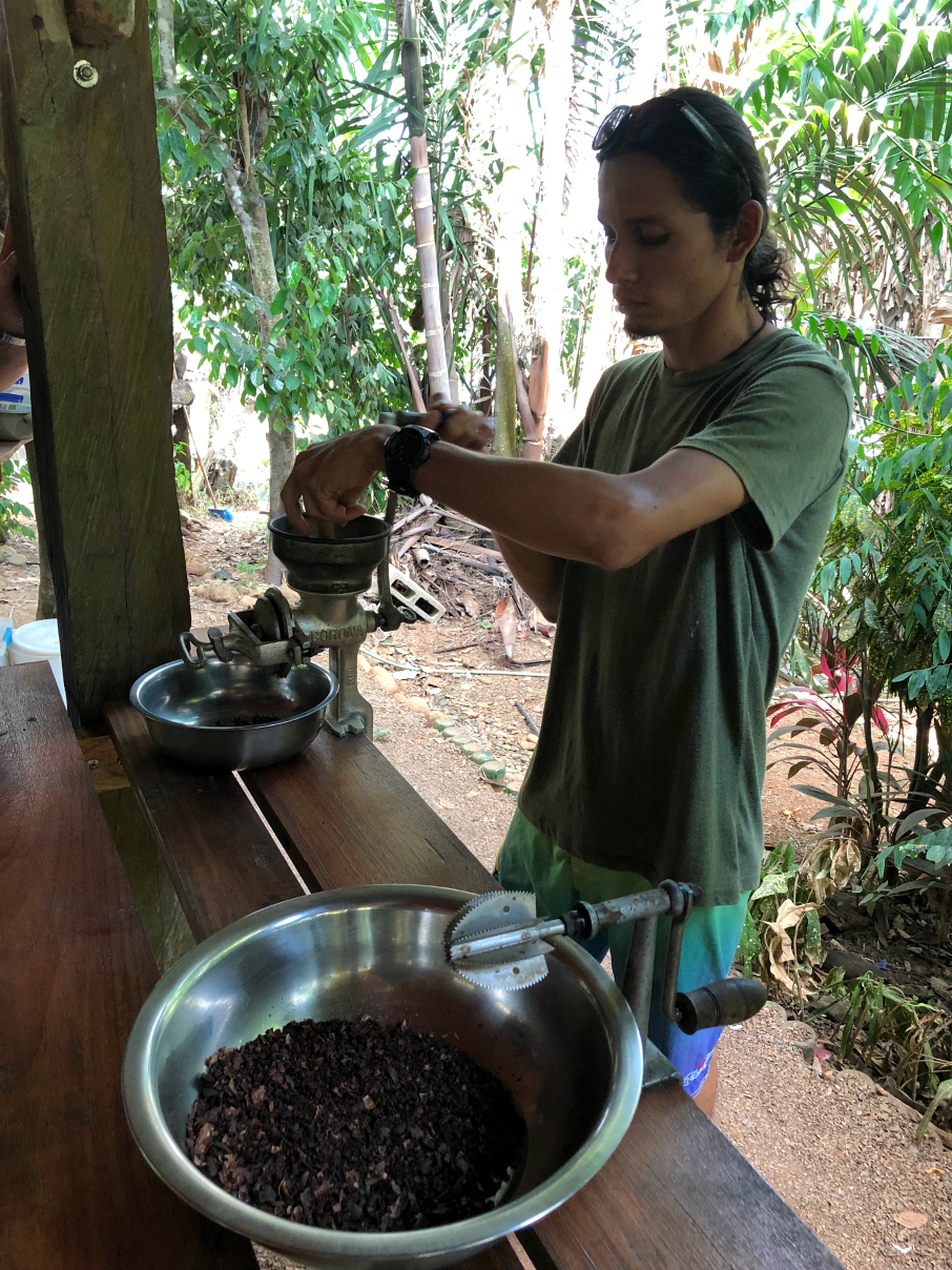 George crushing the cocoa beans to make cocoa. La Iguana Chocolate Costa Rica 